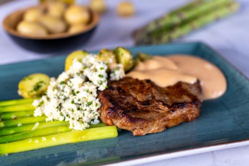 Veal ribeye steak with asparagus and egg mimosa