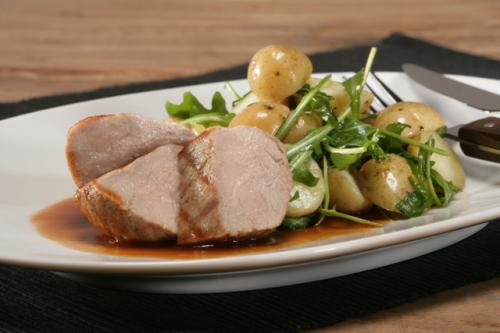 Grilled veal escalope with warm salad of new potatoes in their skins, lemon zest and rocket