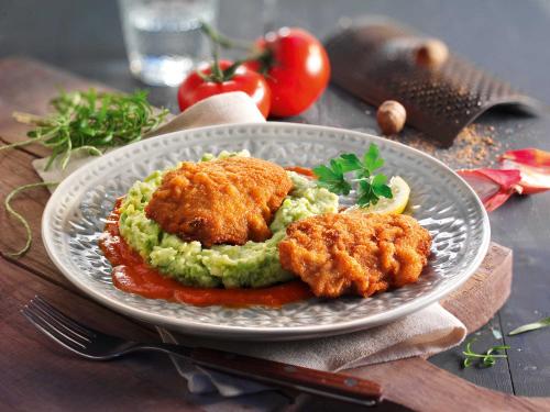 Veal schnitzel with garden pea puree and tomato sauce